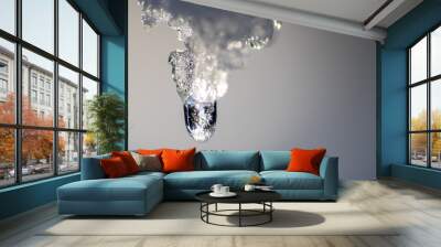 Melting icicle with dripping water drop with crystal clear water drop from melting ice show global warming effect and climate change for melting glaciers indicates end of winter on bright sunshine day Wall mural