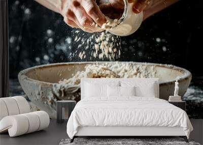 Baking Process - Hands Pouring Proven Yeast into Flour Mixture in Large Bowl on Dark Background Wall mural