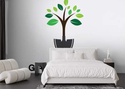 Gardening logo with shovel icon and tree with green leaves logo template. Wall mural