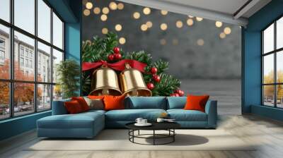 Gold Christmas bells adorned with holly and ribbons, festive ambiance with lights. Wall mural