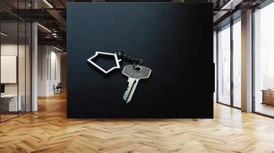 Home key with house keyring on black wood table in dark tone, real estate concept Wall mural