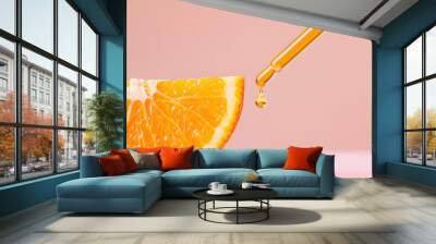 A vibrant orange slice with a dropper adding fresh oil, showcasing the fusion of fruit and vitamin c serum. Wall mural