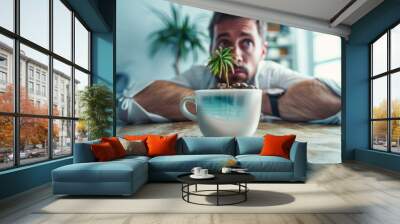 Coffee cup oasis, coffee cup with a tiny palm tree and beach scene floating inside, and a exhausted businessman leans heavily on the desk, burnout and missing holidays. Wall mural