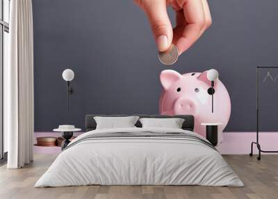 Save money for future concept. Man hand insert coin into pink piggy bank with stack of coins on the table, minimal style background with copy space. Wall mural