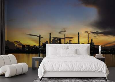 Silhouette oil refinery and Petrochemical plant at dusk at sunrise Wall mural