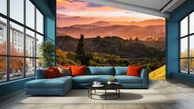 Expansive panorama in Santa Cruz mountains, with hills and valleys illuminated by the sunset light; San Francisco Bay Area, California Wall mural