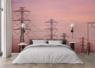 Sunset view of high voltage electricity towers on the hills of San Francisco bay area; Wind turbines visible in the background; California Wall mural