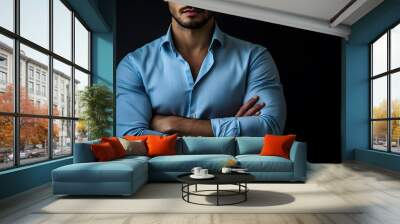 A man in a blue button-down shirt with his arms crossed. Wall mural