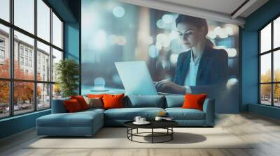 Businesswoman working on laptop at night in a brightly lit office Wall mural