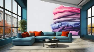 Stack of Pink, Purple, and Blue T-Shirts on White Background Wall mural