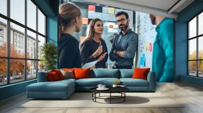 Three Professionals Discussing Business Strategy on a Whiteboard with Sticky Notes Wall mural