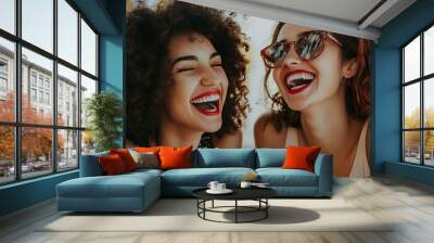 Two women with curly hair laughing together Wall mural