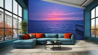 the horizon of a calm sea with a beautiful red sunset. Wall mural