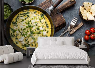 omelette with spinach and cheese in a pan on the concrete background top view Wall mural