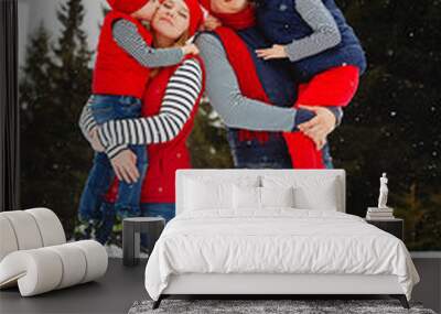 Mother, father and two sons having fun in snow winter Wall mural