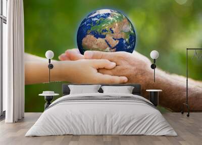 child and man holding earth in hands Wall mural