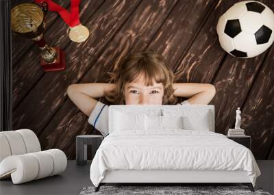 Child is pretending to be a soccer player Wall mural