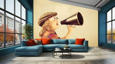 Child shouting through vintage megaphone Wall mural