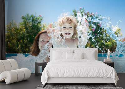 Child with mother in swimming pool Wall mural