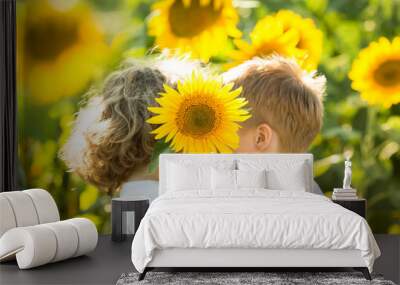 Children hiding by sunflower Wall mural