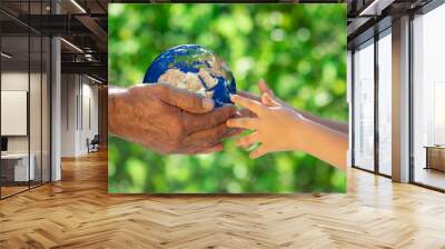 Family holding Earth planet in hands.Elements of this image furnished by NASA Wall mural