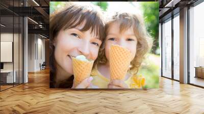 Happy child and mother eating ice cream Wall mural