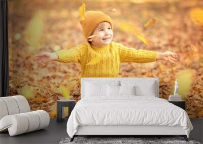 Happy child having fun outdoor in autumn park Wall mural