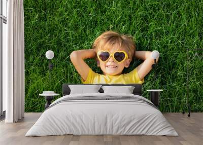 Happy child playing outdoor in spring park Wall mural