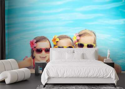 Happy children in the swimming pool Wall mural