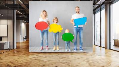 Happy family holding colorful paper speech bubble blank Wall mural