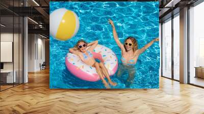 Happy family playing in outdoor pool Wall mural