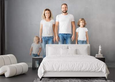 Happy family standing against grey background Wall mural