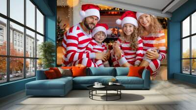 Happy family with children near fireplace at Christmas Wall mural