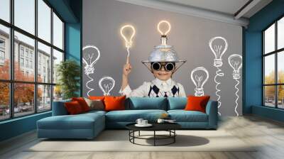 smart child wearing funny helmet with illuminated lightbulb Wall mural