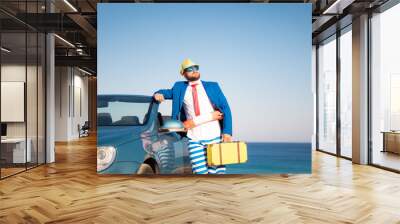 Successful young businessman on a beach Wall mural