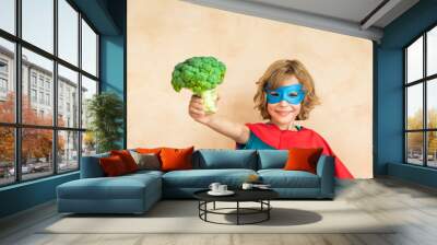 Superhero child eating superfood Wall mural