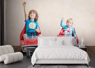 Superheroes children driving toy cars at home Wall mural