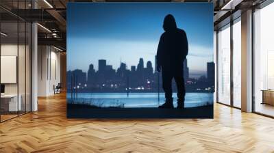 night city scene with silhouette of dangerous criminal man wearing hood and looking for a victim, il Wall mural