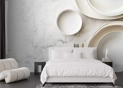 White plates and bowls arranged on a marble surface with a fork. Wall mural