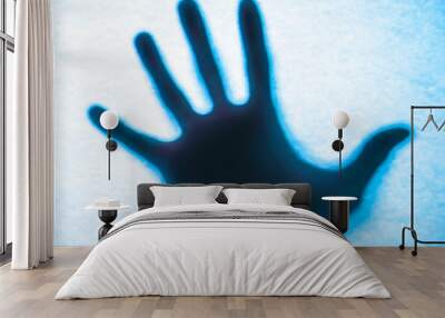 Shadow hands of the Man behind frosted glass. Wall mural