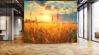 A stunning sunset over a golden wheat field with dramatic clouds and sun rays, capturing the beauty of nature. Wall mural