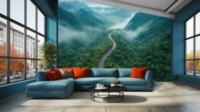 a winding road in the middle of a forest with a misty, cloudy sky above. the road is surrounded by t Wall mural