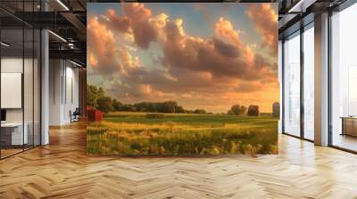 Beautiful sunset over a rustic red barn and silos in a lush countryside landscape with dramatic clouds and golden sunlight. Wall mural