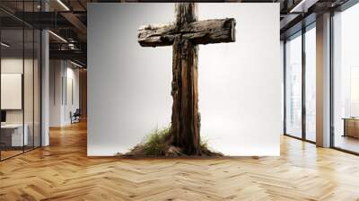 A weathered wood cross stands in dirt, isolated on a simple grey background. Ideal for modern designs requiring a textured, rustic feel Wall mural