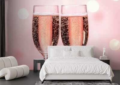 Elegant Champagne Glasses with Sparkling Wine Against a Soft Pink Bokeh Background Wall mural