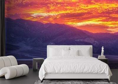 Serene Sunset in Death Valley: Straight Road Bathed in Radiant Colors Wall mural