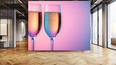 Two Elegant Champagne Glasses with Bubbles Against a Vibrant Pink and Blue Gradient Background Wall mural