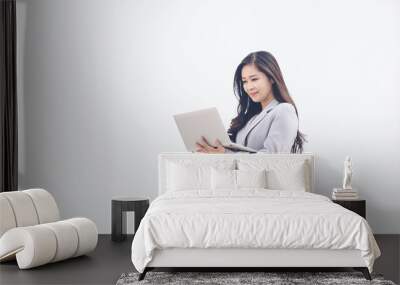 Business woman using laptop computer on white background Wall mural