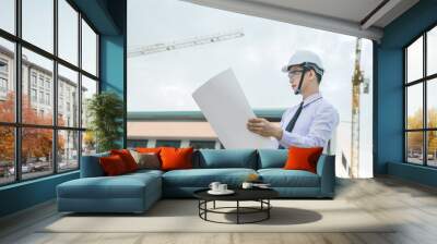 smiling young architect or engineering builder in hard hat with tablet over group of builders at construction site, architect watching some a construction, business, building, industry, people concept Wall mural