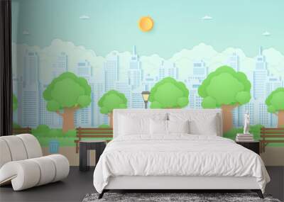 Wooden bench, street light and trash can in the garden with trees, bird on the branch, plant pots and flowers on grass, Cityscape, building background, paper art style Wall mural